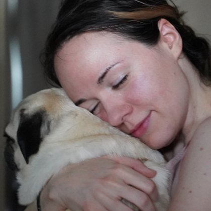 Lulu of Shady Waggers hugging a pug